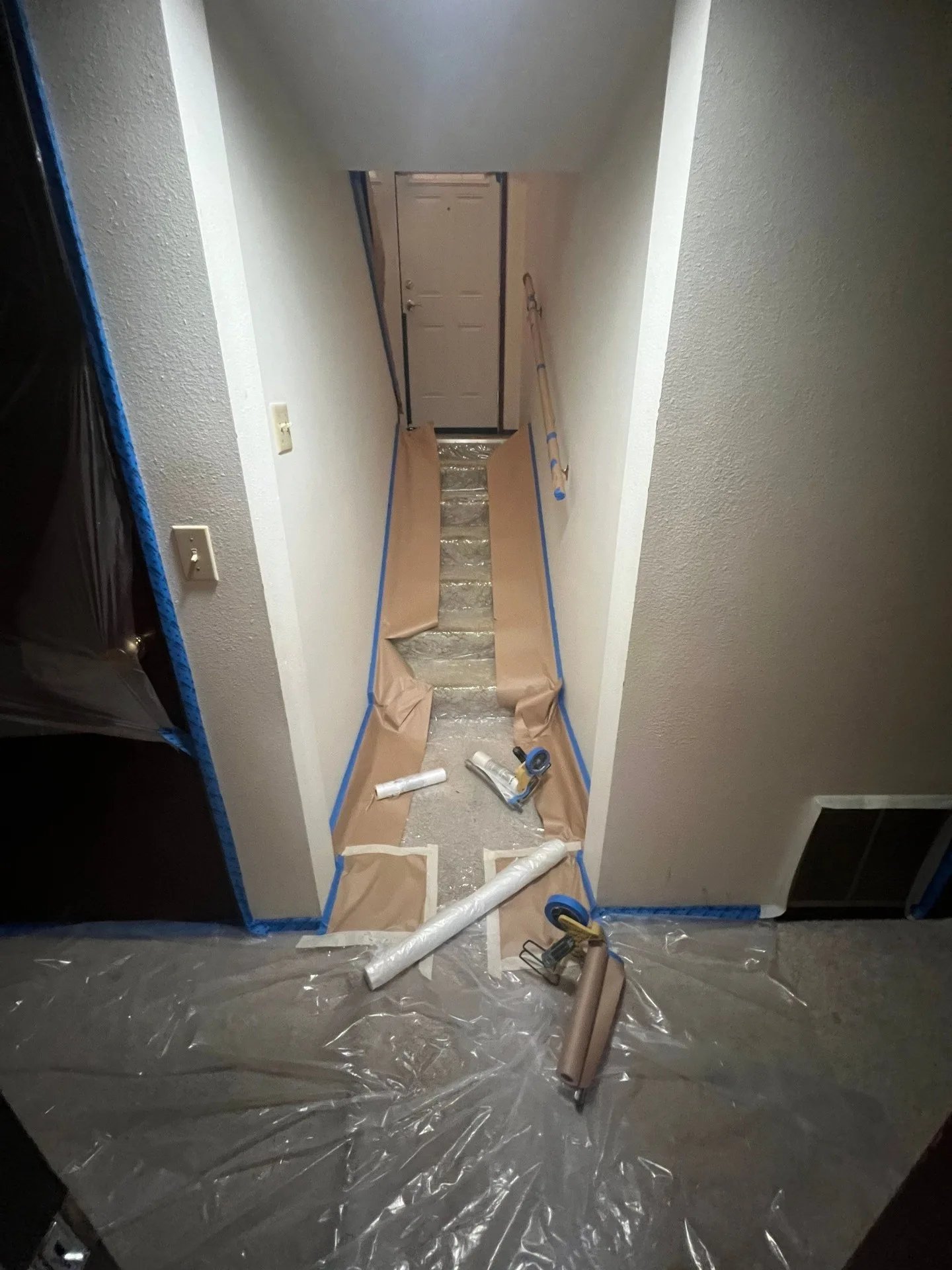 Hallway prepped and protected for drywall repair