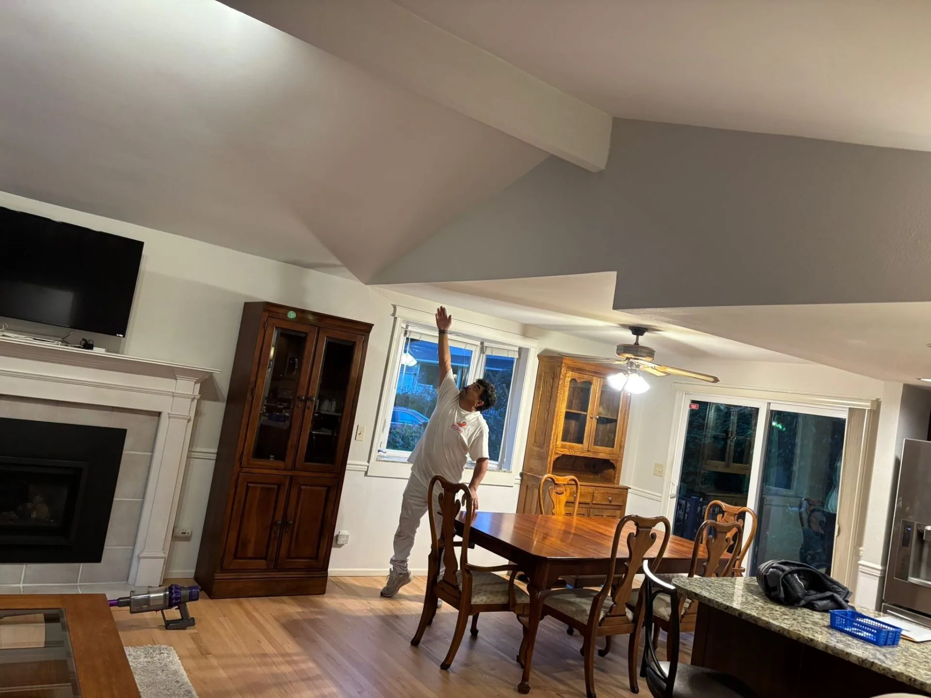 Painter rolling a smooth interior ceiling finish