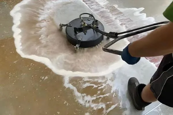Surface cleaner pressure washing a concrete driveway in Bothell